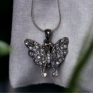 Butterfly pendant, silver tone with rhinestones. Good condition.